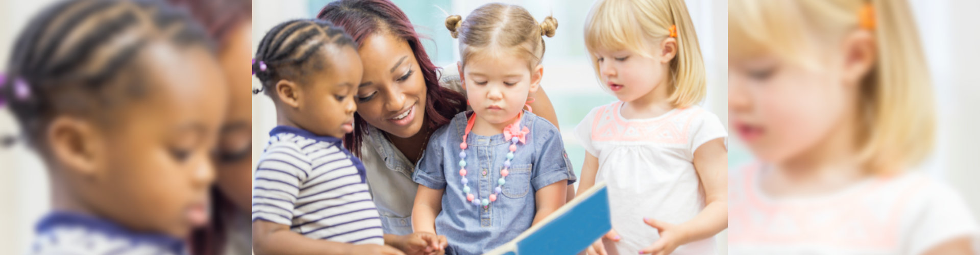 children and a teacher reading a book